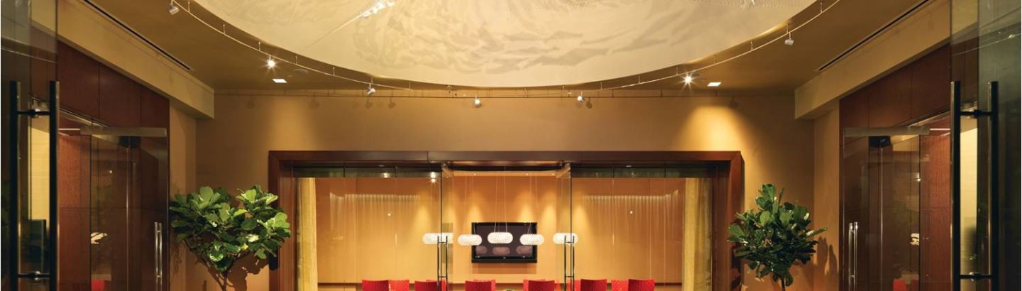 Modern meeting space at Battery Wharf Hotel with red chairs for collaborative events.