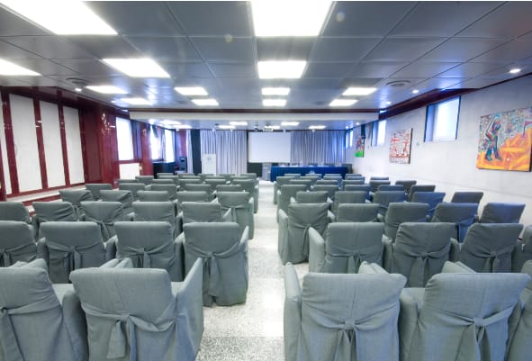 Conference room at Hotel San Rocco with arranged chairs for professional events.