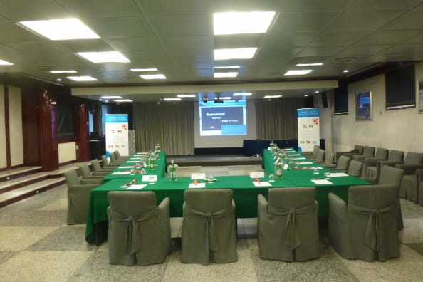 Meeting room setup at Hotel San Rocco with green table for professional events.