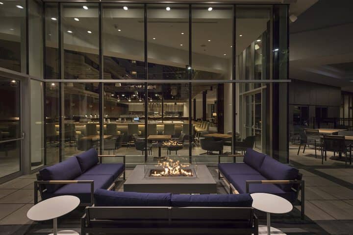 Modern outdoor lounge at Hilton Boston/Woburn, ideal for networking events and gatherings.
