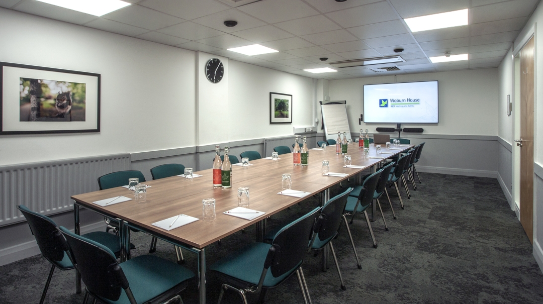 Foster and Bloomsbury Rooms meeting space with large table, ideal for professional events. - Banner