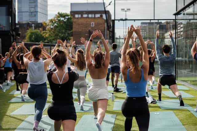 Outdoor yoga session at Padel Social Club for wellness events and team-building retreats.