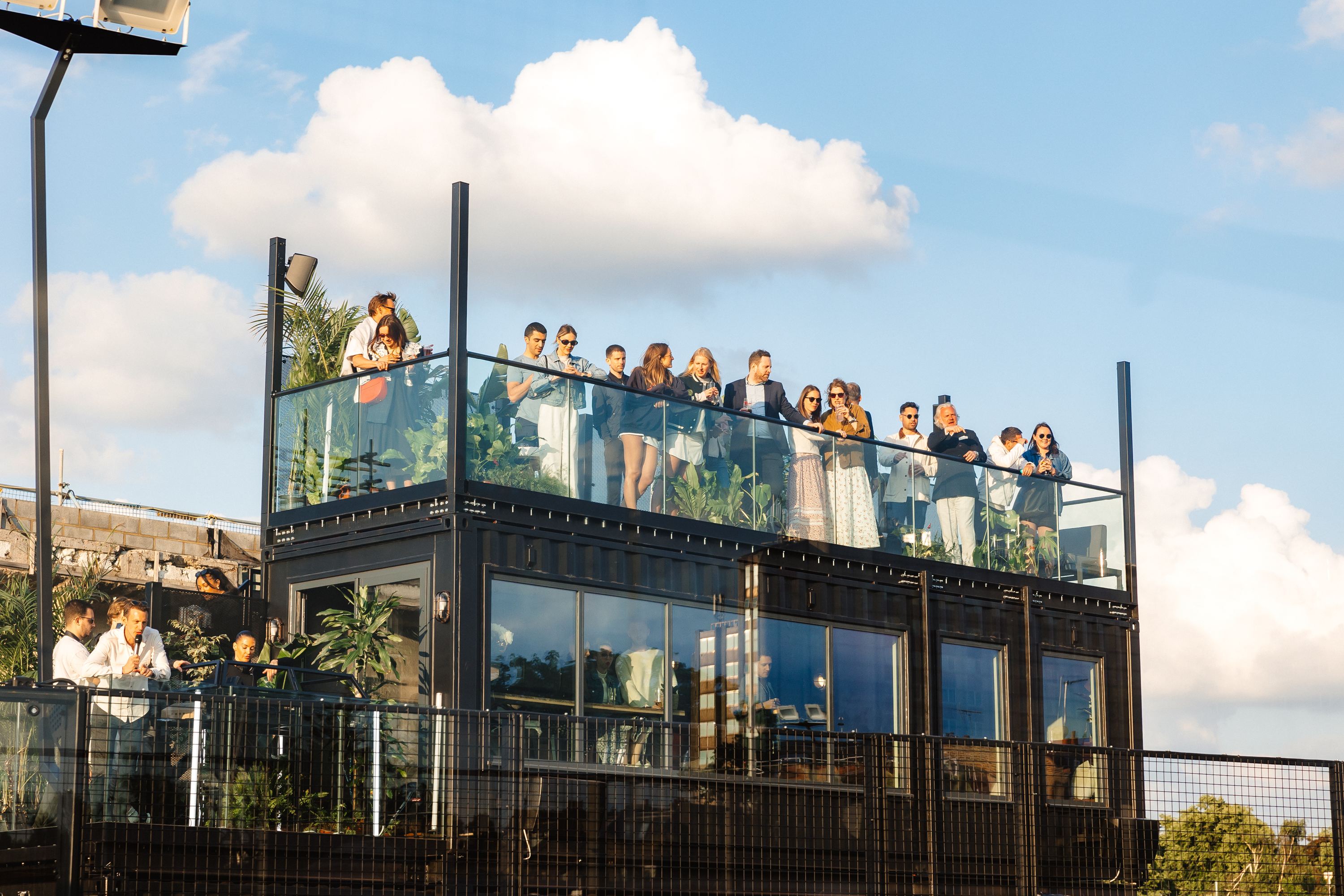 Vibrant rooftop venue at Padel Social Club for networking and social events. - Banner