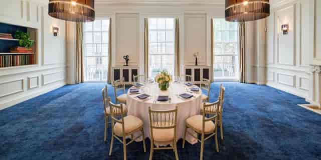 Elegant round table in well-lit event space for corporate meetings and private dinners.