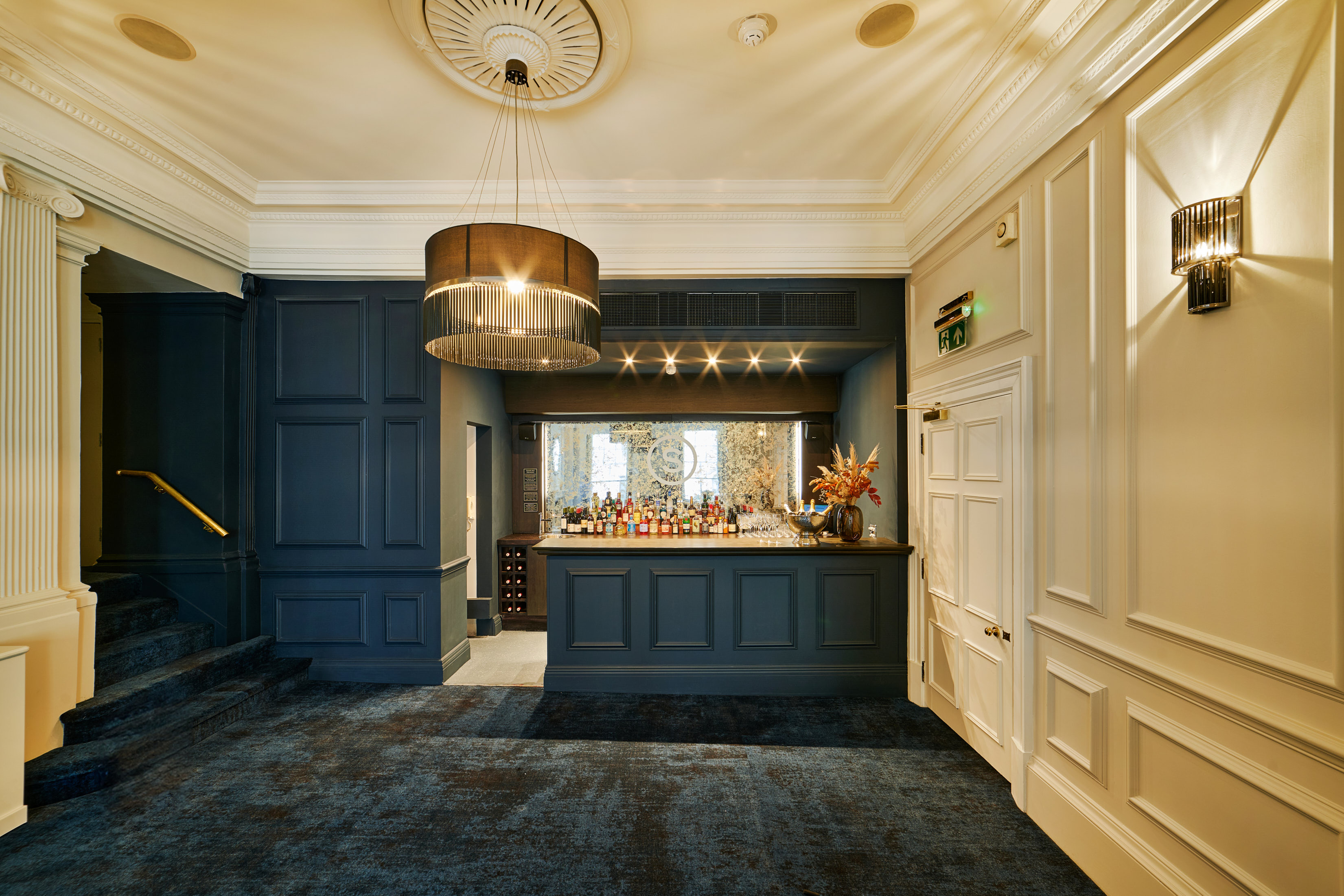 Sophisticated event space with elegant bar, ideal for networking and cocktail receptions. - Banner