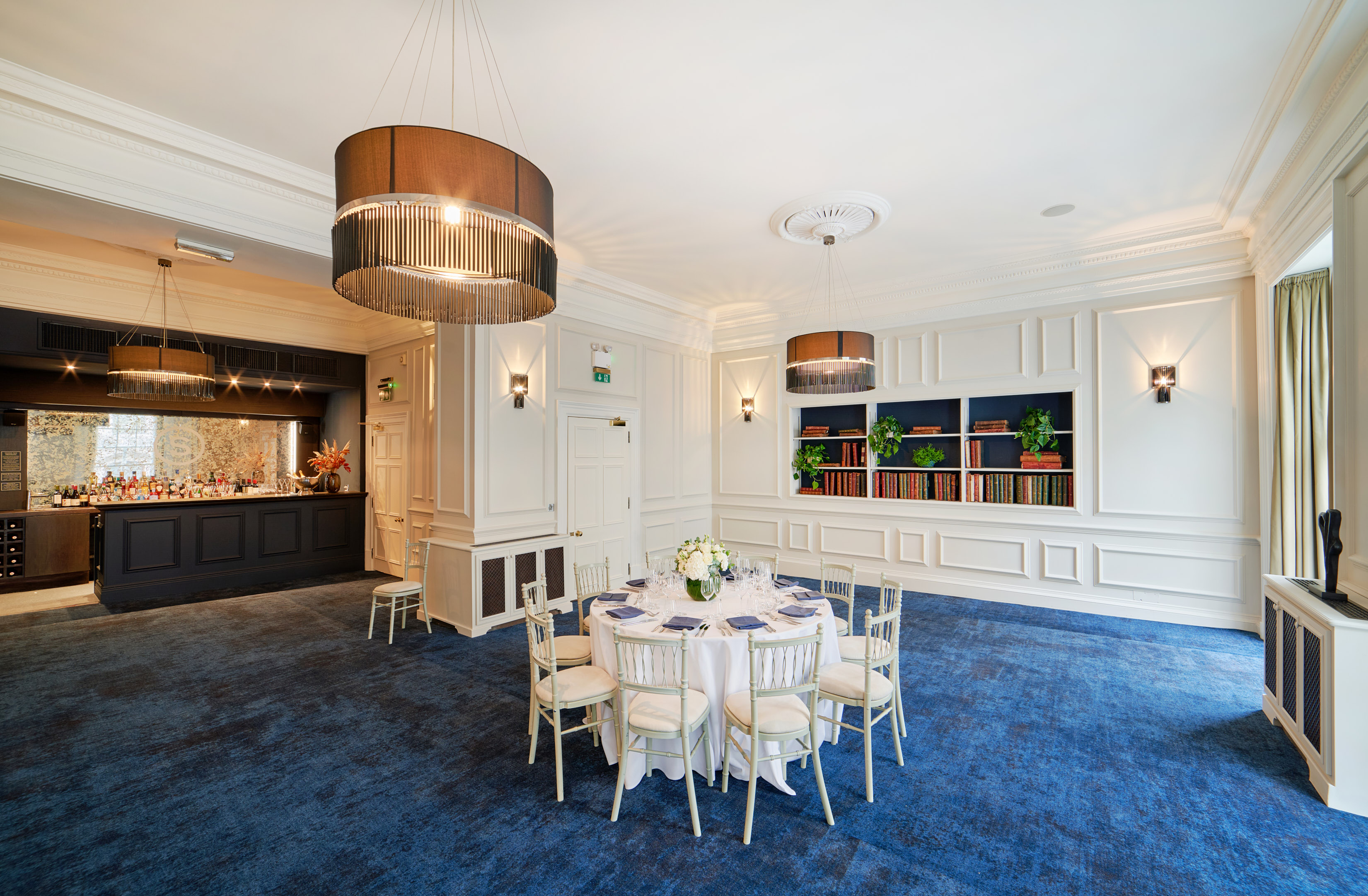 Elegant event space with round table, chandeliers for corporate functions and private celebrations. - Banner