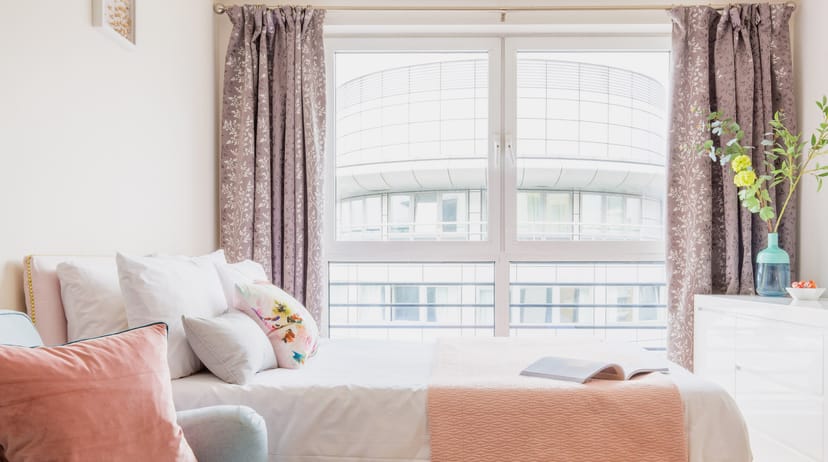Cozy hotel room with natural light, ideal for events and meetings.