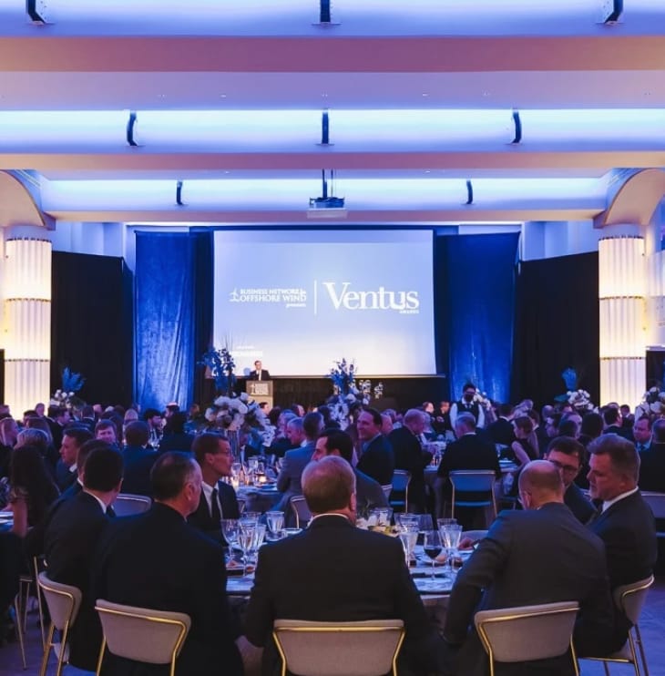 Hamilton Ballroom gala with elegant tables, blue lighting, and floral decor.