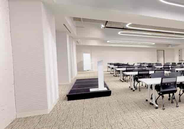 Versatile meeting space at The Forum, featuring an elevated podium for engaging presentations.