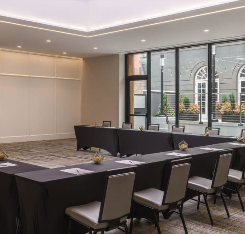 Meeting room at The Bader Ginsburg, featuring U-shaped tables for corporate events.