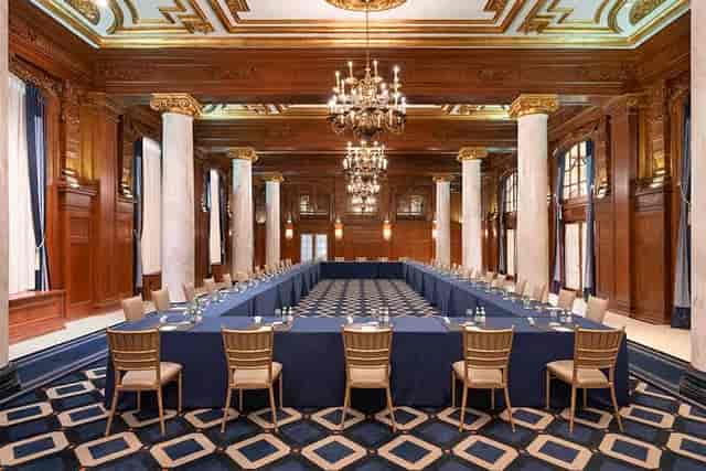 U-shape boardroom setup in historic mahogany-paneled Willard Room for executive meetings.