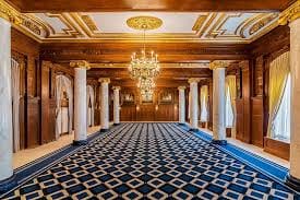 Elegant Willard Room with ornate paneling, ideal for upscale meetings and events.