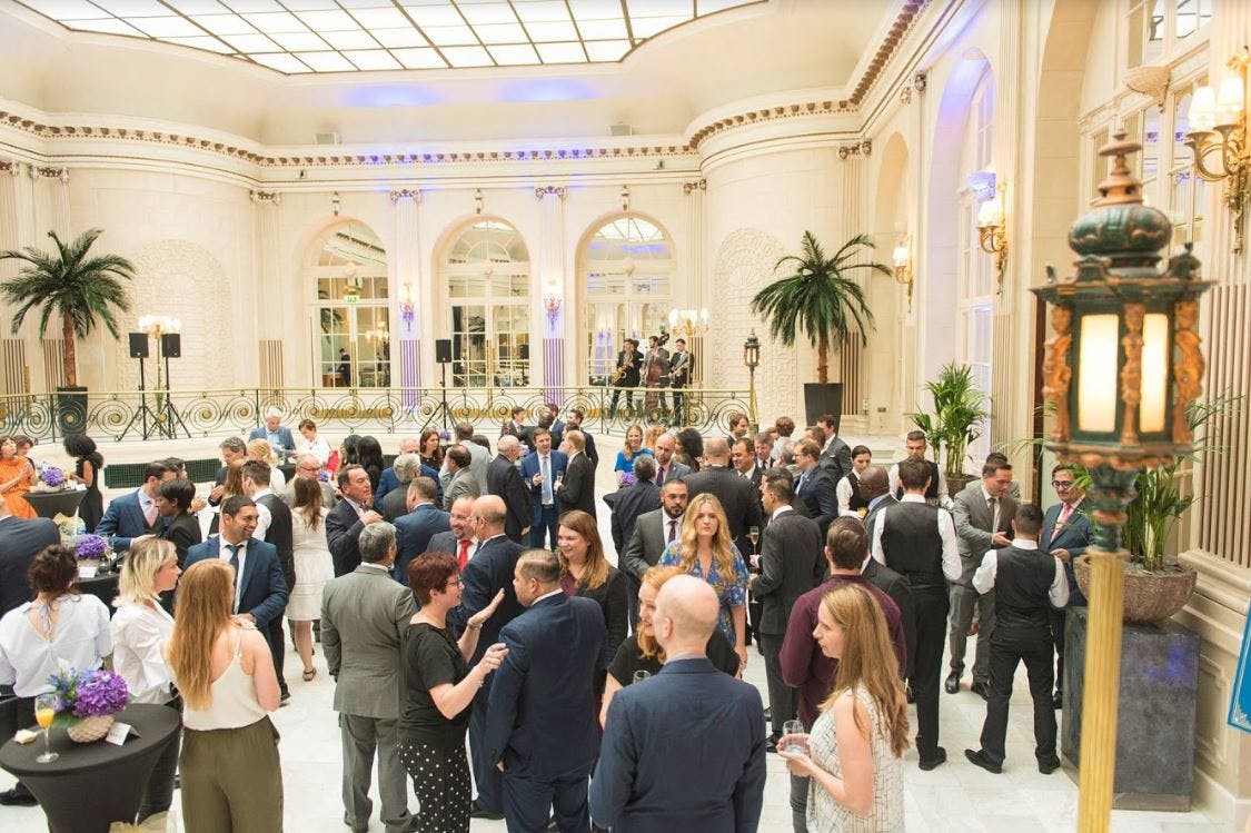 Vibrant networking event at The Waldorf Hilton conference center, London.