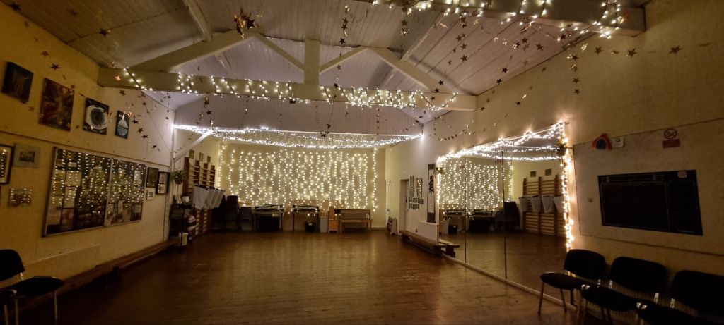"Cozy event space with fairy lights at Signol Community Centre for gatherings and workshops." - Banner