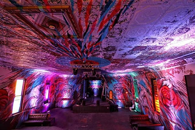 Vibrant event space with colorful murals, ideal for creative performances and parties.