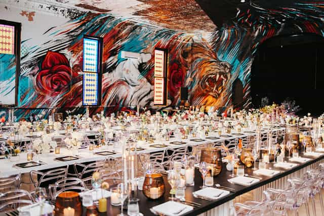 Vibrant event space with mural backdrop, perfect for gatherings and celebrations.