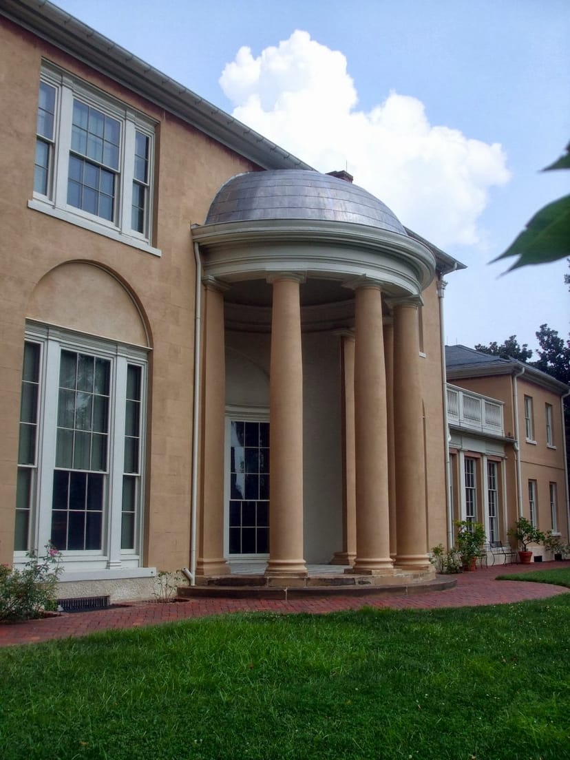 Elegant Tudor Place landmark with columns, ideal for weddings and corporate events.