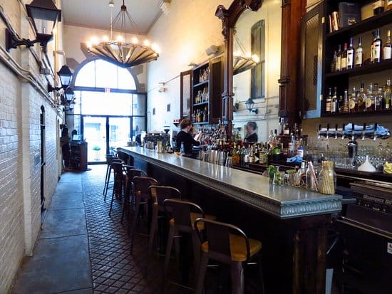 Indoor dining room bar with polished countertop, perfect for networking events and gatherings.