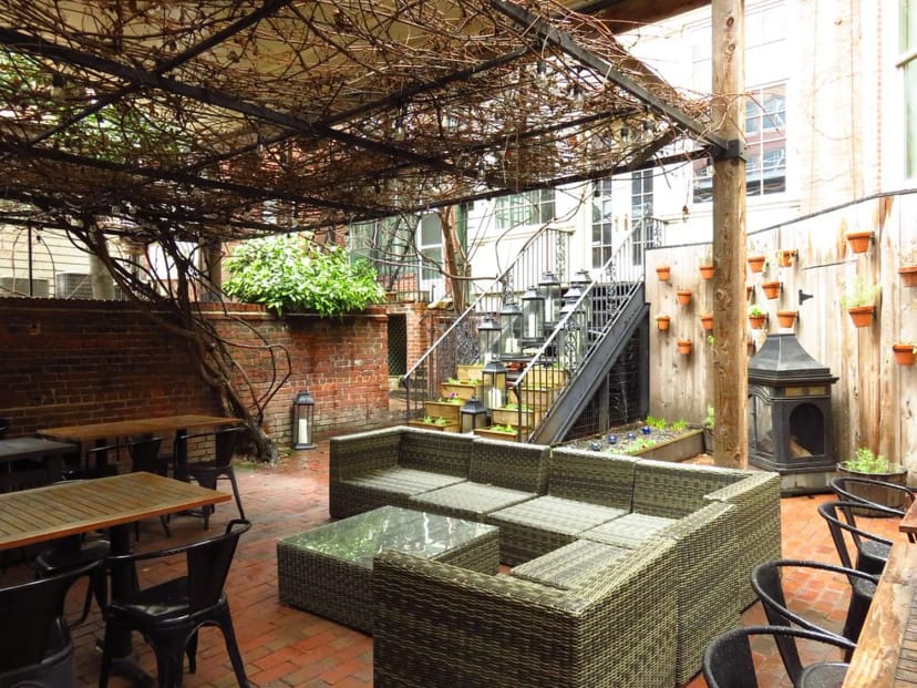 Charming outdoor venue with rustic brick walls for intimate gatherings and networking events.