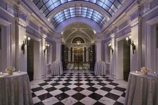 Elegant foyer with checkered floor in The Gallatin Room, ideal for upscale events.