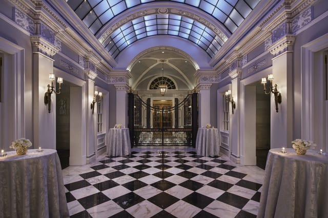 Elegant foyer with checkered floor in The Gallatin Room, ideal for upscale events.