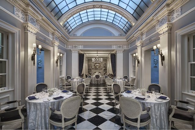 Elegant event space in The Gallatin Room, featuring high ceilings and upscale decor.
