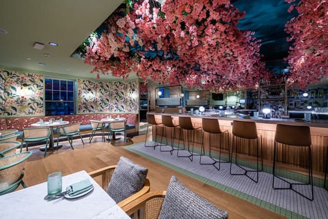Vibrant Ambar Restaurant with floral ceiling, ideal for events and gatherings.
