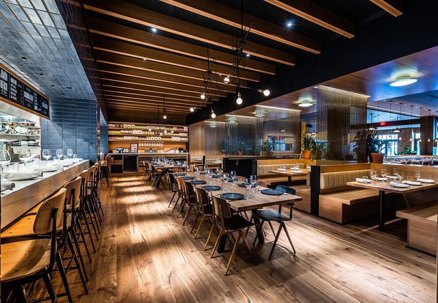 Modern restaurant interior in Boqueria, warm wood tones, perfect for networking events.