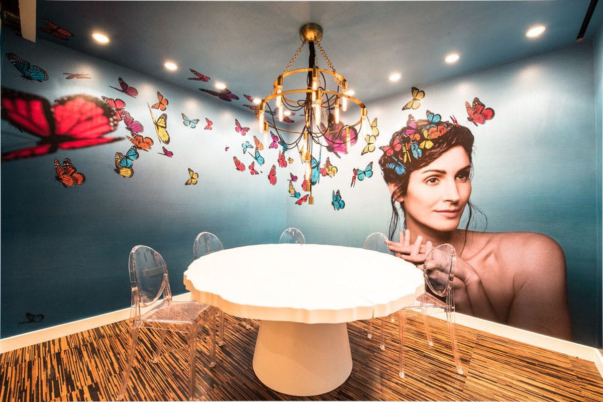 Vibrant meeting space with butterfly mural, ideal for creative events and gatherings.