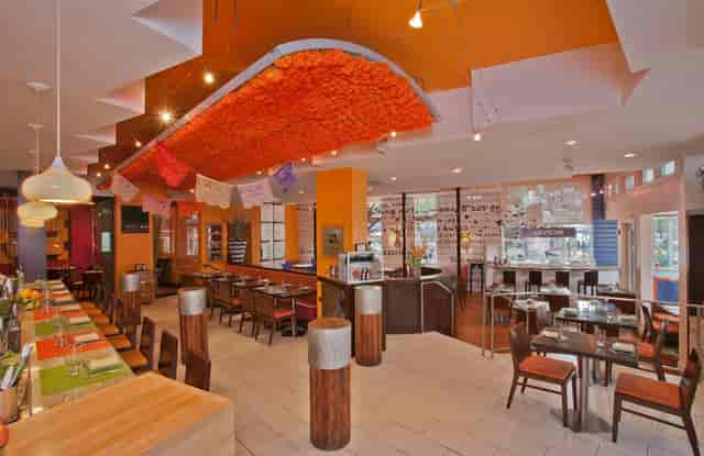 Vibrant Butterfly Bar & Tables in Oyamel, perfect for meetings and casual events.