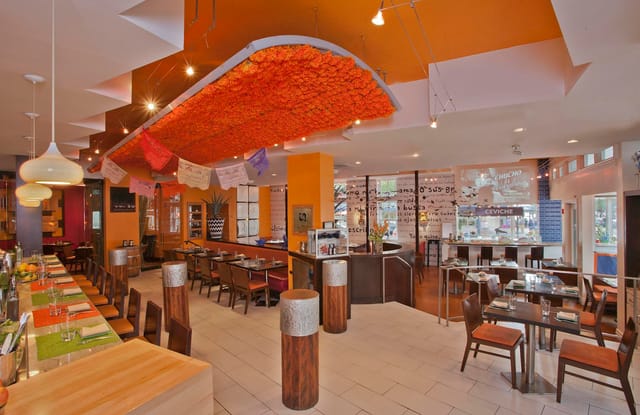 Vibrant Butterfly Bar & Tables in Oyamel, perfect for meetings and casual events.