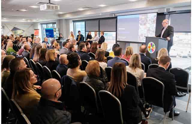Engaged audience at Connexin Live auditorium during a professional conference.