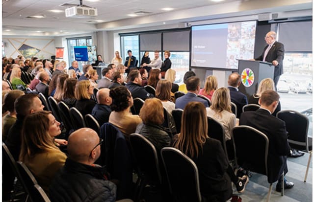 Engaged audience at Connexin Live auditorium during a professional conference.