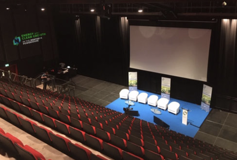 Main Auditorium at Connexin Live, Hull - stage set for panel discussion, professional event space. - Banner