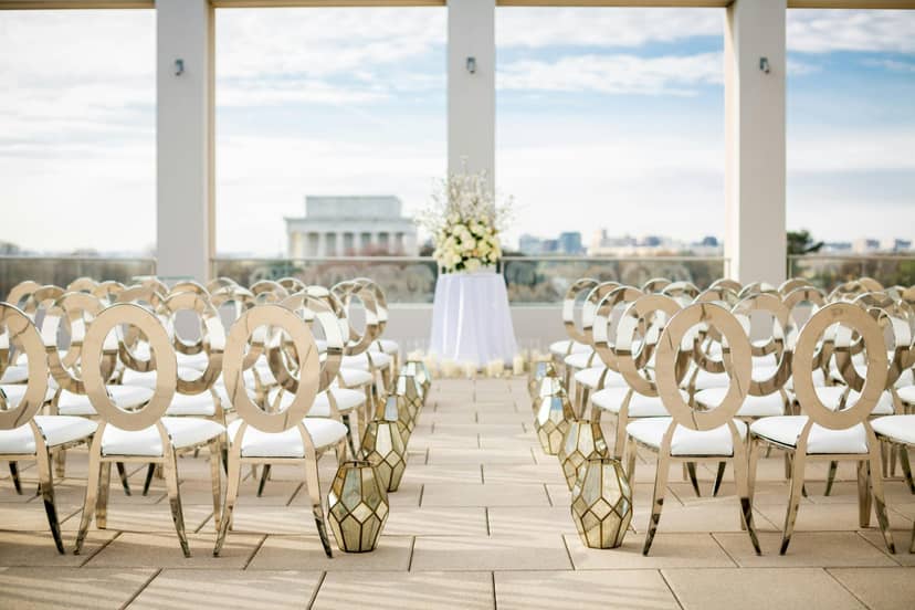 Elegant outdoor ceremony space with gold chairs at United States Institute of Peace.