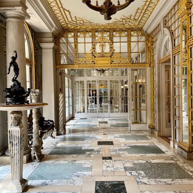 Elegant entryway with gold detailing and marble flooring, ideal for luxury events.