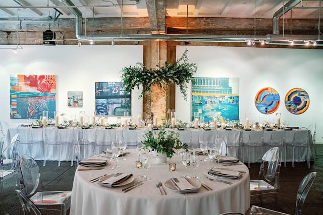 Elegant art gallery event space with fine dining setup for sophisticated dinners and galas.