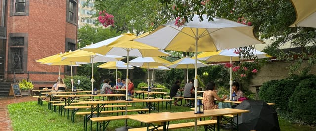Biergarten at Heurich House Museum with umbrellas, ideal for summer gatherings and events.