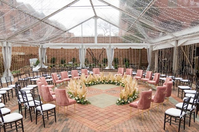 Courtyard in Decatur House with pink chairs, perfect for outdoor workshops and gatherings.