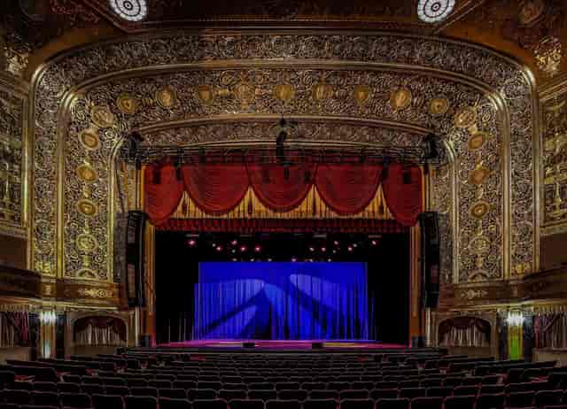 Ornate theater stage at Warner Theatre, perfect for conferences and gala events.