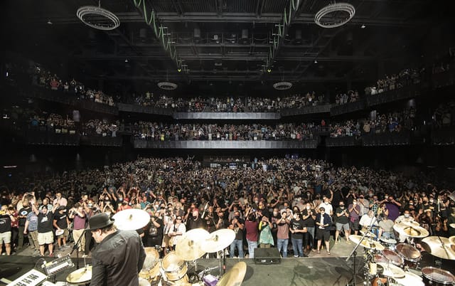 Packed concert hall at The Anthem with vibrant audience, showcasing live event atmosphere.