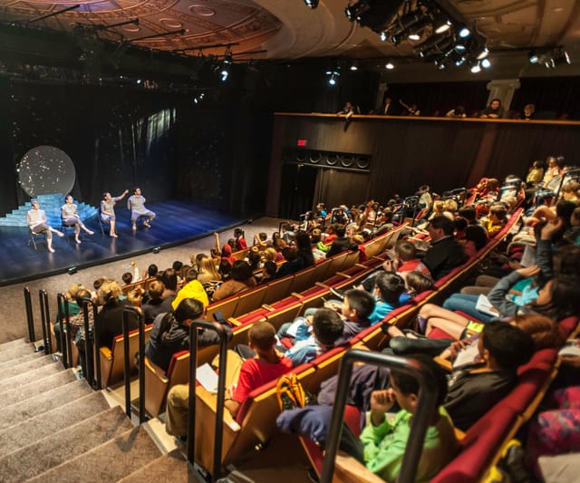 Vibrant GALA Theatre stage with engaged children audience at a live performance event.