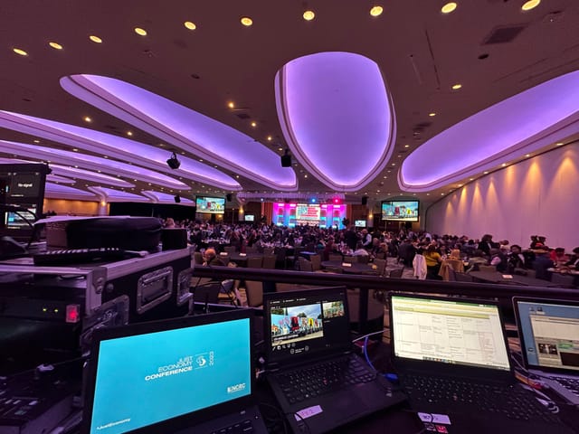 Ballroom at Washington Hilton with purple lighting for a multimedia conference event.
