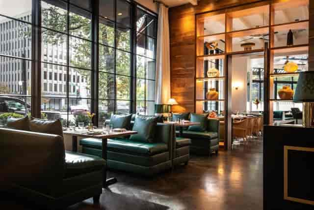 Stylish meeting space at St. Gregory Hotel with large windows for events and networking.
