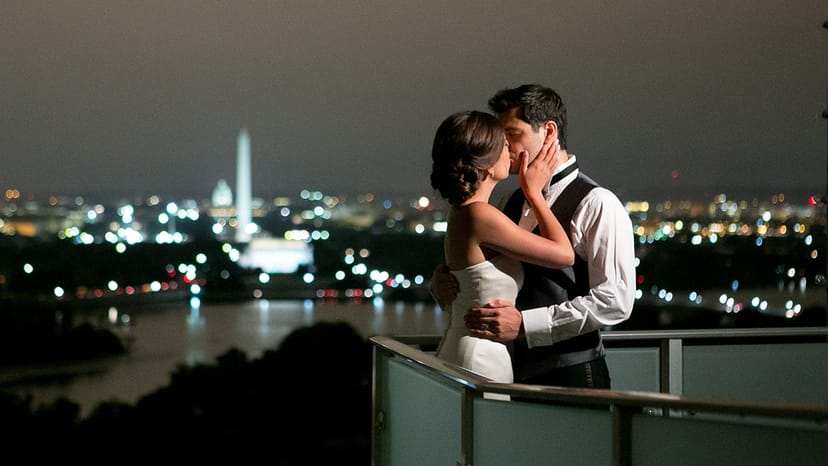 Romantic couple in Penthouse with cityscape, perfect for weddings and upscale events.