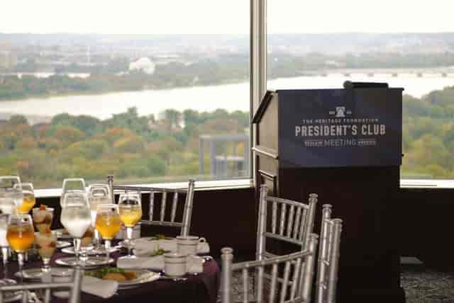 Sophisticated conference facility with elegant dining setup and panoramic views.