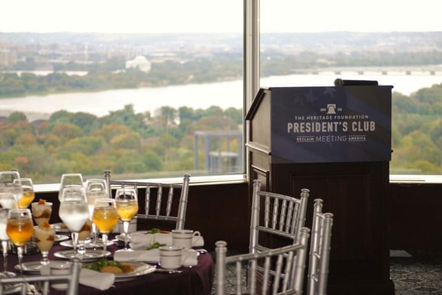 Sophisticated conference facility with elegant dining setup and panoramic views.