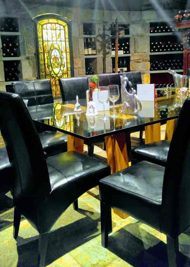 Wine Cellar meeting space with glass table and leather chairs for exclusive events.