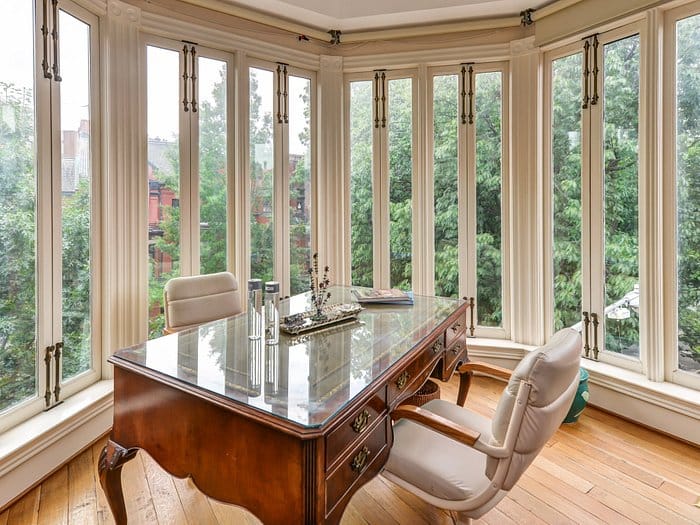 Elegant conference room with large wooden desk, ideal for meetings and brainstorming.