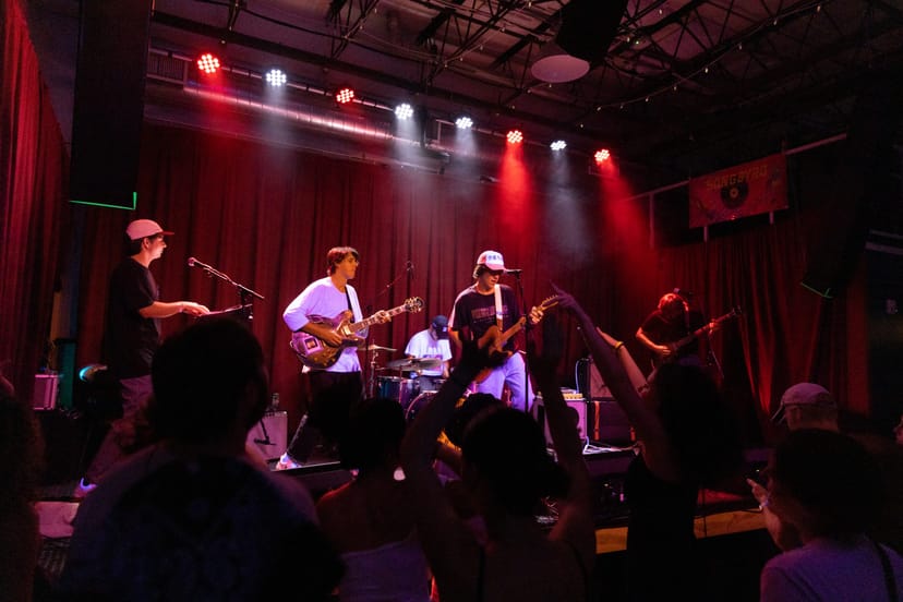 Live music performance at Songbyrd Music House with vibrant lighting and engaged audience.